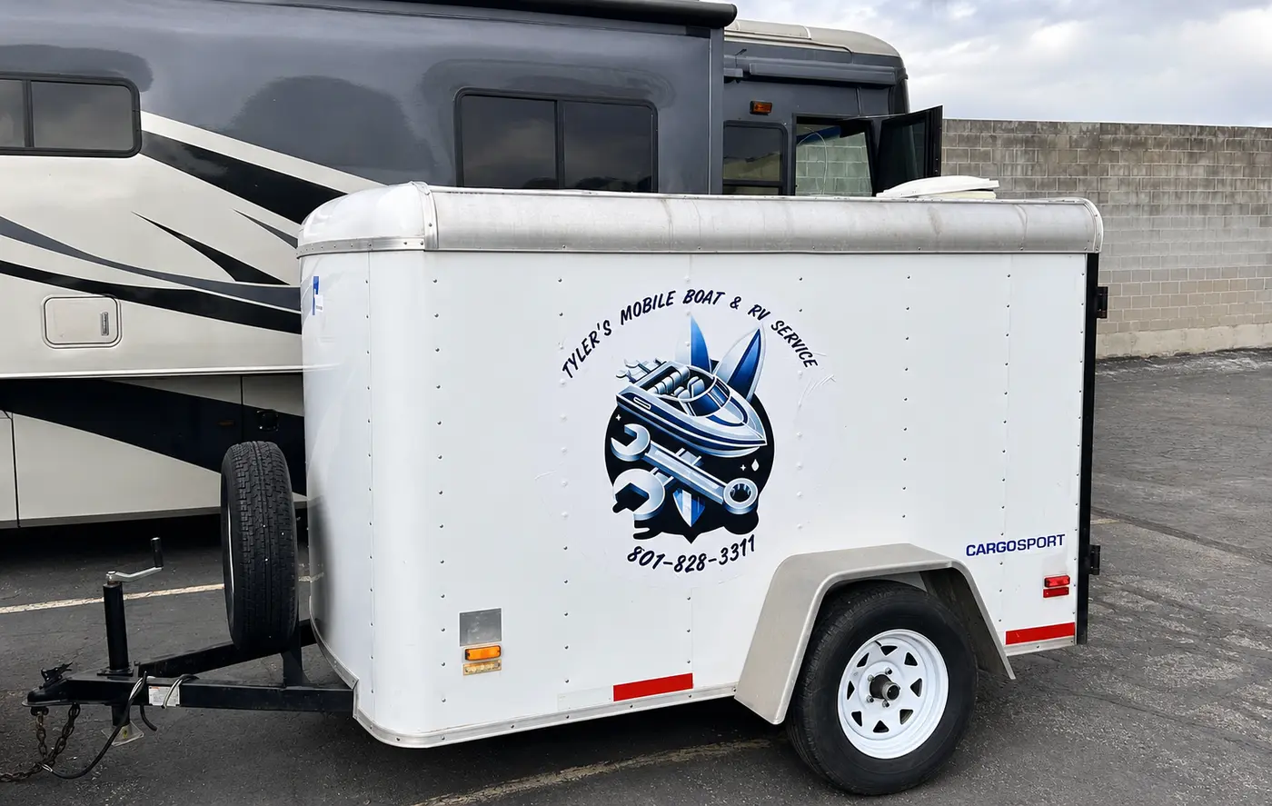 Tyler's Mobile Boat and RV Service enclosed service trailer beside an RV