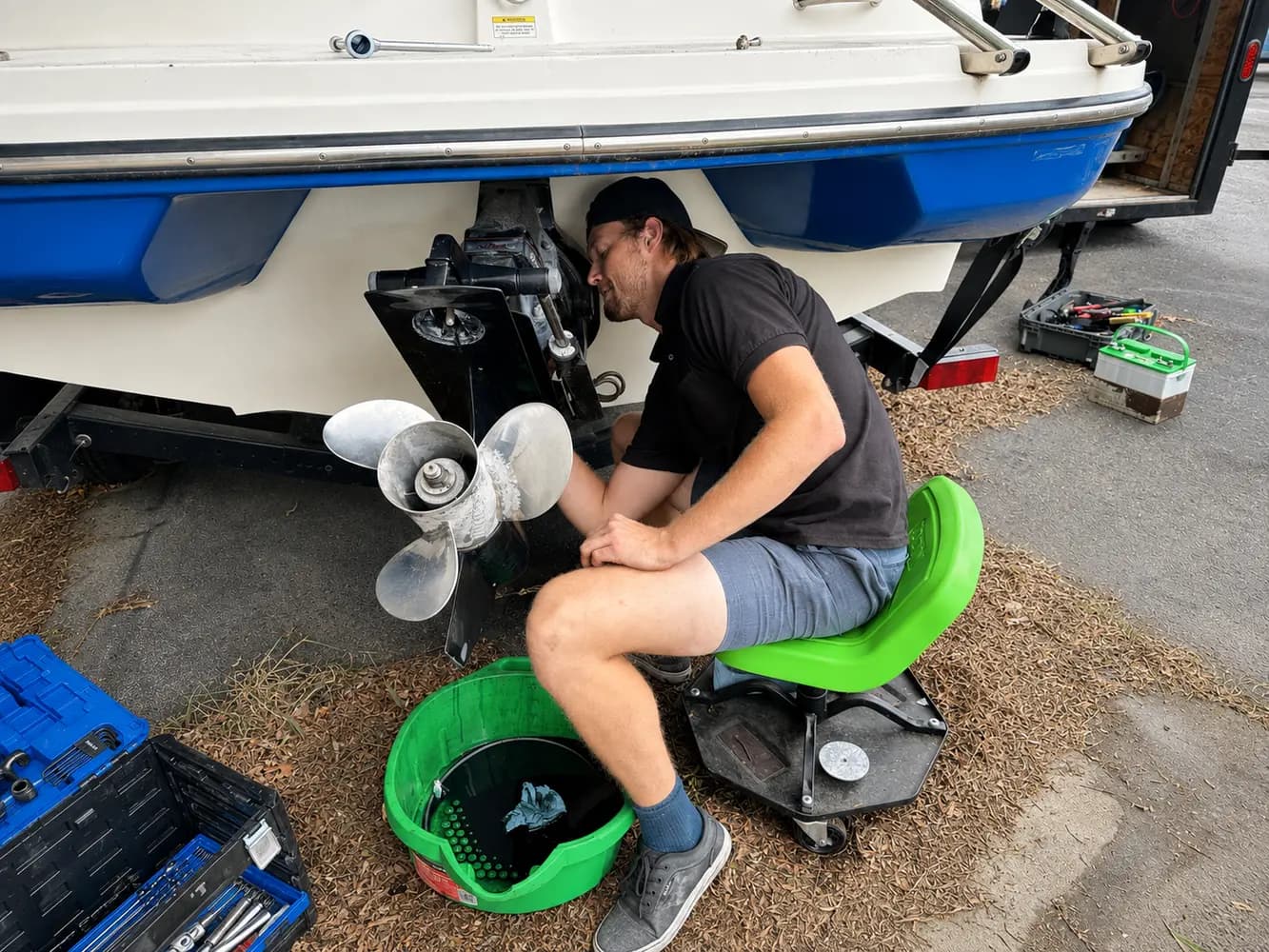 Tyler performing hands-on sterndrive maintenance at a customer's location in Utah